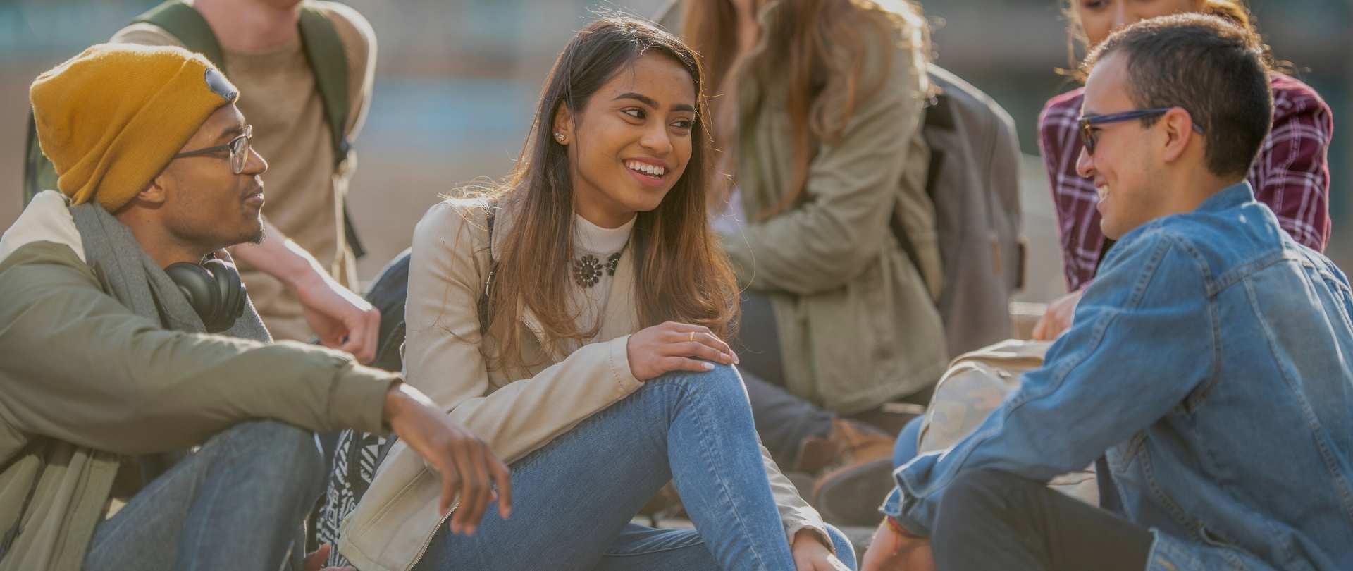 three young adults hanging out and smiling