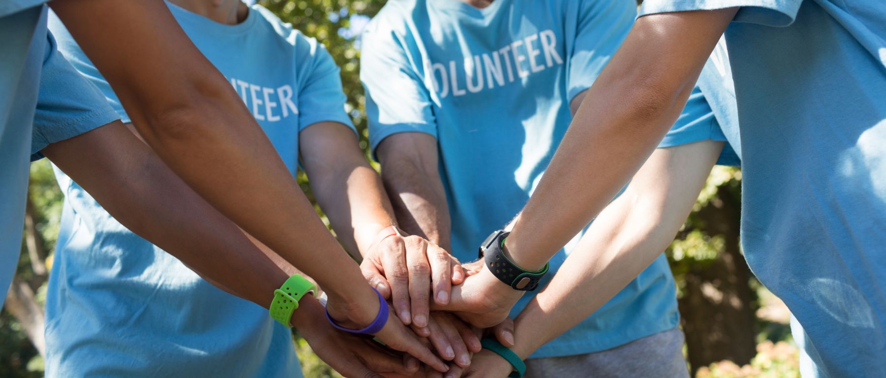 hands of volunteers coming together during training